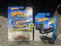 Two Hot Wheels Colour Shifters Camaro cars, new on card, with color change feature advertised on packaging.