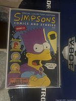 Photo of the front cover of Simpsons Comic Issue #1 showing Bartman in superhero costume, with text and price visible.