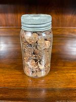 Jar filled with Canadian pennies, front view