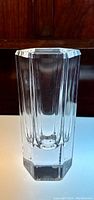 Front view of clear hexagonal crystal vase showing vertical fluted facets and thick base.