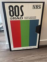 Canvas print designed like an oversized VHS or Hi-8 tape cover with '80s Rad' theme. Features three vertical colored stripes and bold text.