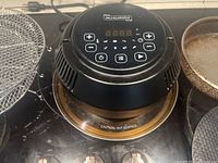Close-up of MICHELANGELO air fryer lid control panel showing digital display and buttons.