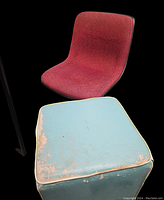 Red fabric chair and blue worn ottoman showing paint wear and distress