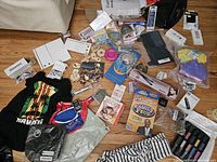 Full overview of miscellaneous items including clothing, books, games, and accessories on a table.