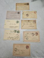Eight vintage international postal covers showing various stamps, postmarks, and handwritten addresses on beige and off-white paper.