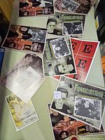 Overhead photo showing a scattered arrangement of multiple vintage horror movie posters including Frankenstein and Dracula.