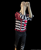 Side front view of mannequin model showing costume details with arms raised.