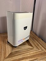 Full view of the white crosscut shredder unit showing its compact and rectangular design, including a front window to monitor the waste bin level.