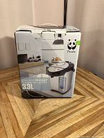 Boxed Panda Electric Water Dispensing Pot showing front and side of the packaging with capacity and branding.