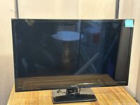 Front view of Panasonic LCD TV on wooden table.