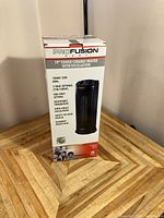 Photo of the new Fusion 19-inch tower ceramic heater in its original box, showing front product details