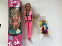 Three Barbie dolls as described: original boxed pink bikini Barbie, loose pink outfit Barbie, small vintage Barbie sealed in packaging