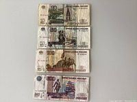 Front sides of 10, 50, 100, and 500 Russian ruble banknotes from 1997 showing various historic Russian themes.