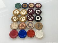 Top view of all 20 casino chips showing various designs and colors including German and Cuban chips.