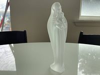 Front view of Virgin Mary holding Baby, showing detailed features and frosted glass texture.