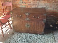 Full view of Henredon Chinese cabinet showing brass details and wood finish.