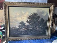 Full view of the large printed canvas landscape inside ornate gold frame, showing overall condition and framing details.