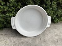 Top view of the white ceramic pie plate showing handles and interior surface with light use marks.