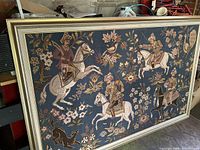 Frontal view of the large framed tapestry depicting four mounted archers and floral elements.