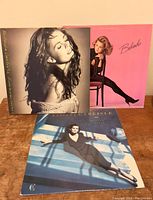 Front covers of three Belinda Carlisle vinyl LP records: 'Belinda', 'Heaven on Earth', and 'Runaway Horses'.