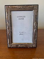Front view of ornate vintage Godinger silver photo frame for 4x6 photos