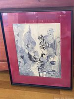 Frontal photo of the framed watercolour showing entire artwork and frame placed on wood floor near wall.