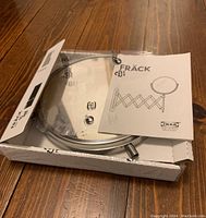 Two images showing the IKEA FRÄCK dual mirror in its original packaging, unopened with instructions included.