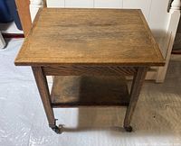 Clear image of the top and side of the wooden hobby table showing grain and wheel details.