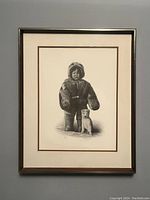 Full view of framed artwork depicting boy and dog in winter clothing and fur boots.