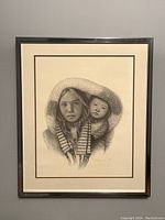 Framed black and white drawing of a mother and child in fur-lined clothing, signed and numbered by F. Lorenzo.