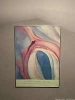 Front view of the framed print hanging on a wall showing the artwork and text below