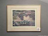 Frontal shot showing the framed poster with water lilies and reflections in an impressionistic style with muntins on cream mat and gold frame.