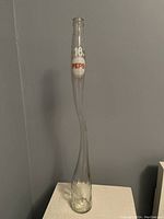 Full view of the vintage stretched Pepsi bottle showing its tall, slender shape and overall condition.