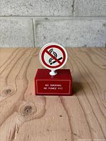 Front view of the small office no smoking sign with English text above French text on red base