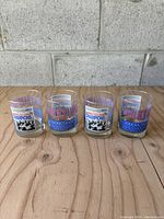 Four vintage 1992 Toronto Blue Jays World Champions drinking glasses lined up showing full front graphics.