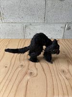 Full side view of the vintage black cat Halloween figure showing fur texture, body shape, and tail.