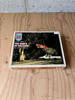 Boxed jigsaw puzzle with The Dukes of Hazzard scene showing the image on the front of the box.