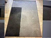 Full view of IKEA Stillebak grey carpet showing two-tone design and overall wear.