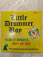 Front cover of the vintage 12-inch greenish yellow Christmas record titled 'Little Drummer Boy' by Arc Sound, featuring The Embassy Chorale and Soloists
