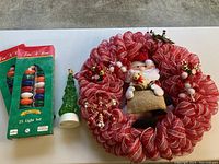 Lot shown with red mesh Christmas wreath with plush snowman center, green glass Christmas tree light decoration, and two vintage green boxed 25-light sets.