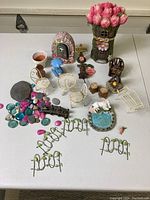 Full view of the fairy garden lot showing miniature furniture and decorative items arranged on a table.