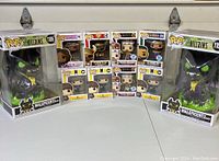 Full lot display showing all eight Funko Pop figures in original boxes including Maleficent Dragon, Flavor Flav, Freddie Mercury, Whitney Houston, and BTS V.