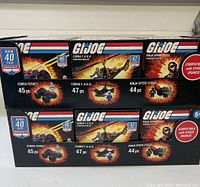 Three GI Joe construction set boxes stacked, showing Cobra Ferret, Cobra F.A.N.G., and Ninja Speed Cycle models with corresponding piece counts and age recommendation.