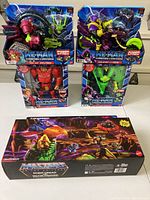 Four He-Man Power Attack action figures in blue packaging, and one boxed Point Dread Talon Fighter vehicle from Masters of the Universe, all new.