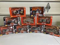 Nine boxed 1:18 scale Harley Davidson miniature motorcycles arranged in three rows, showing the variety of models and box designs.