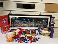 Wide view photo showing the lot with panoramic framed 2004 World Series photograph, plush dolls, toy figures, bobblehead, and Super Bowl belt in box.