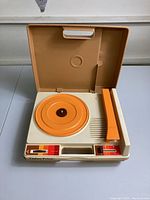 Full view of vintage 1978 kid record player with lid open, showing orange turntable and controls