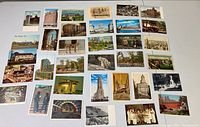 Overview of 37 vintage postcards laid out showing various buildings and landmarks