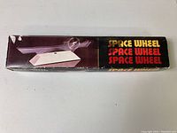 Original box displaying the Space Wheel logo and a photo of the space wheel mounted on a white base.