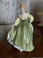 Front view of the Royal Doulton Fair Lady figurine in green dress, 8 inches tall